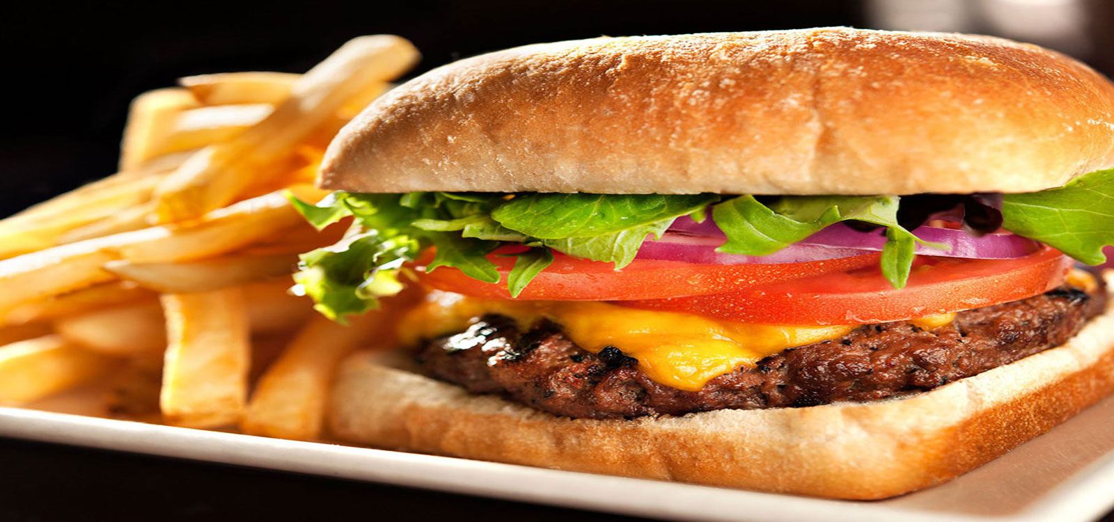 Plate cheeseburger and fries